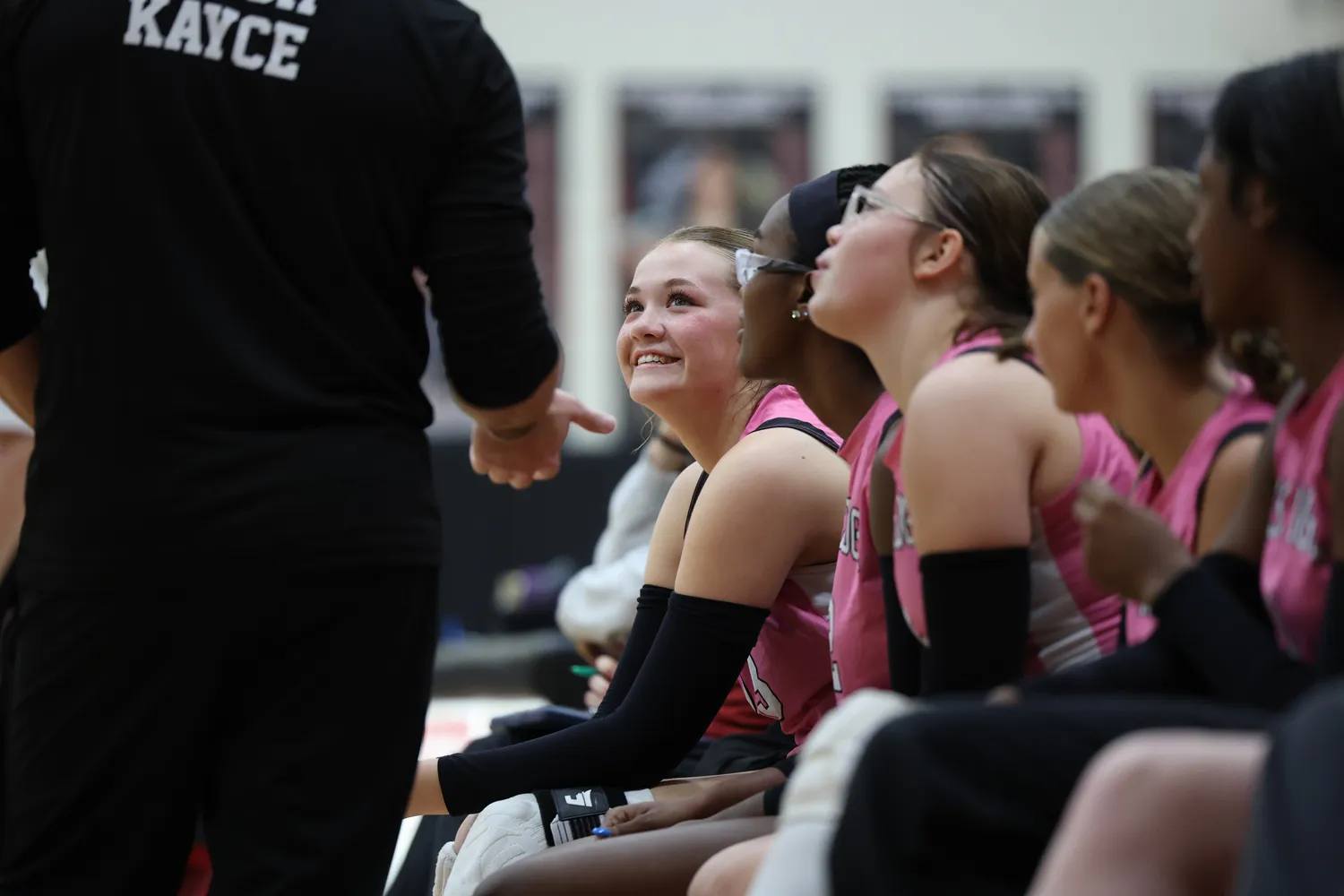 Girls Volleyball big smiles while talking to coach