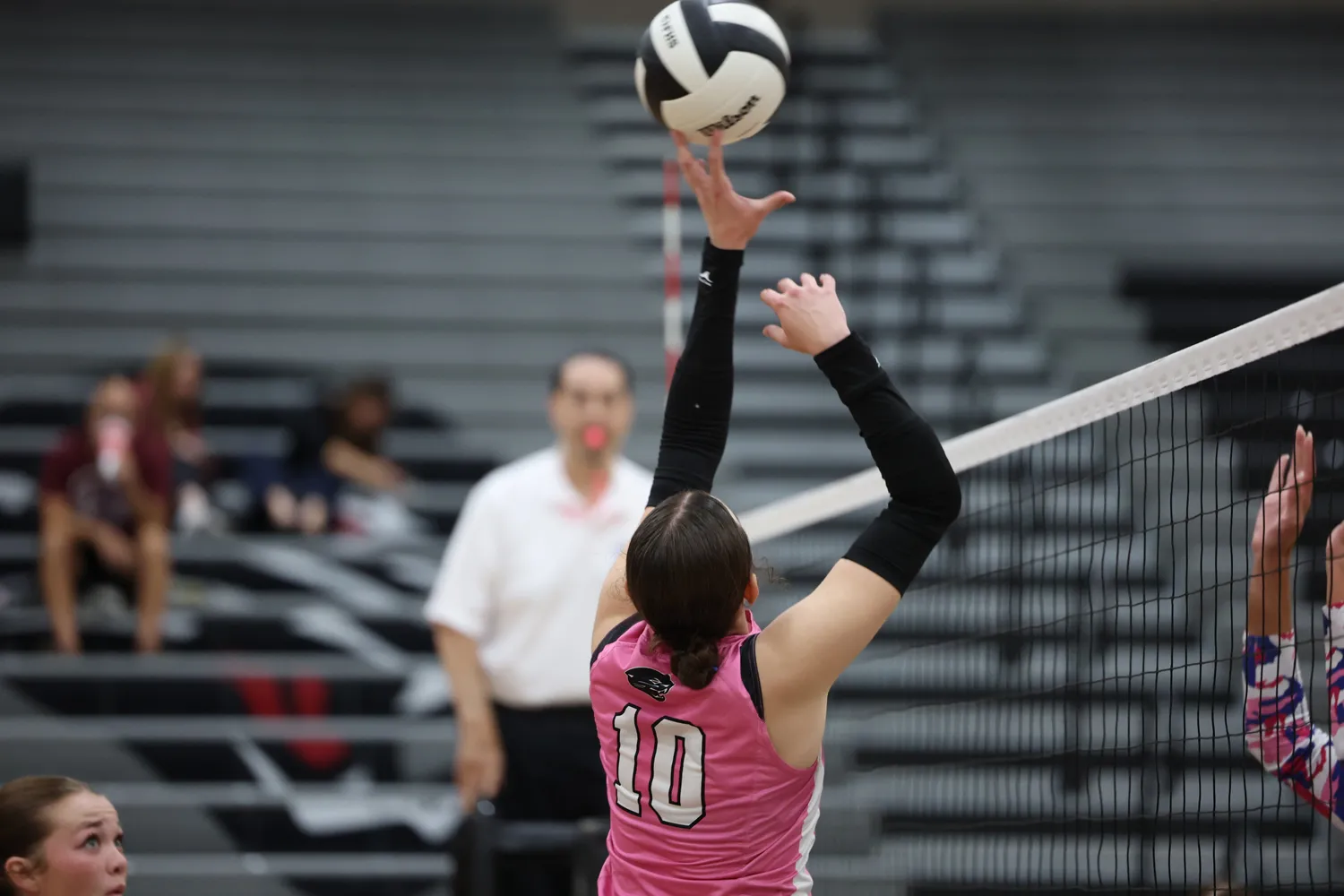 Girls Volleyball tipping the ball over the net